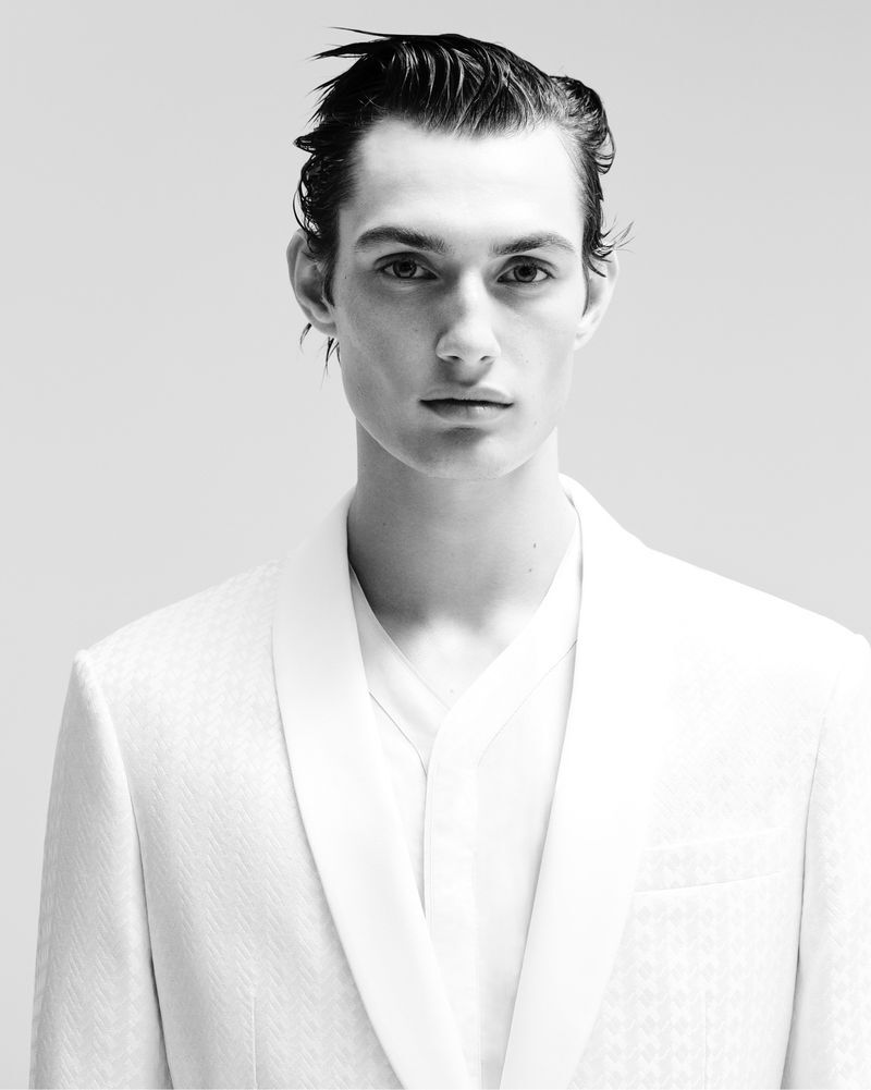 Thatcher Thornton dons a textured white shawl collar jacket from the Giorgio Armani Celestial capsule collection.