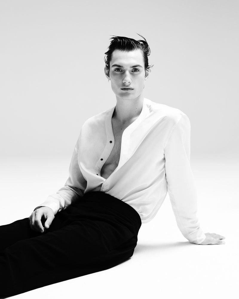 Thatcher Thornton captivates in a crisp, open white shirt and black trousers from the Giorgio Armani Celestial capsule collection.