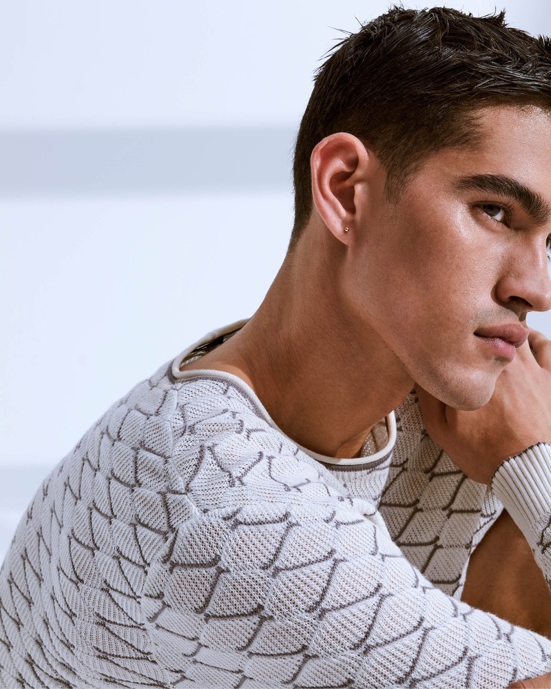 Bodhi Heeck poses in textured knitwear from Giorgio Armani's spring-summer 2024 collection.