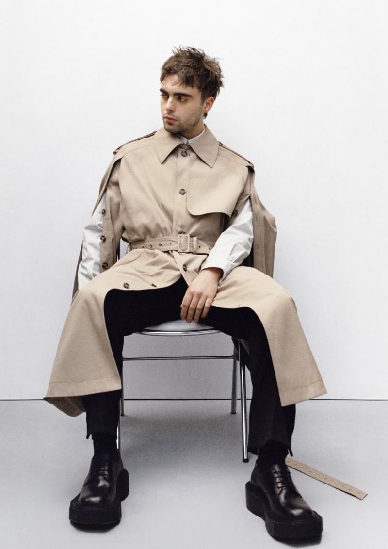 Lennon Gallagher models a beige trench coat from the H&M x Rokh collection. 