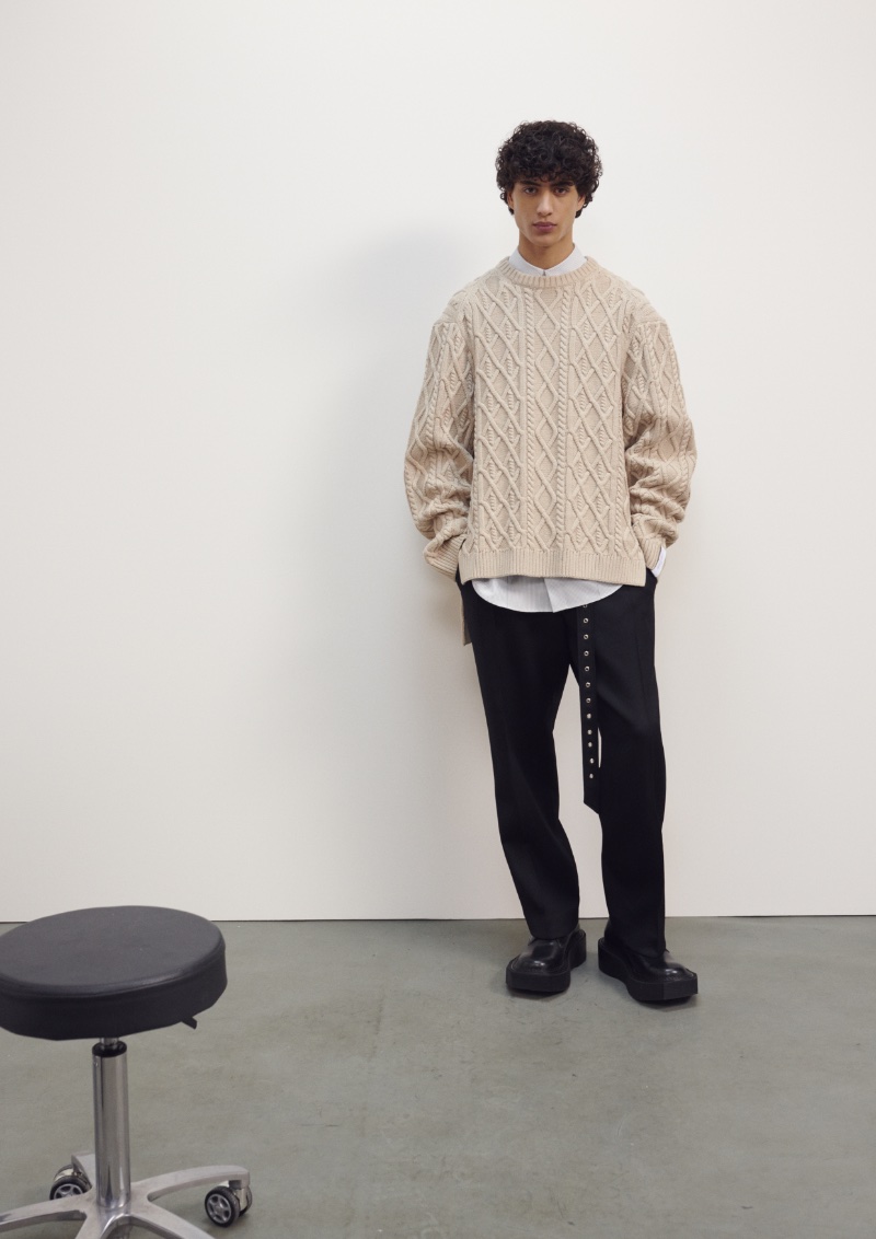 Yoesry Detre models a chunky knit sweater from the H&M x Rokh collection.