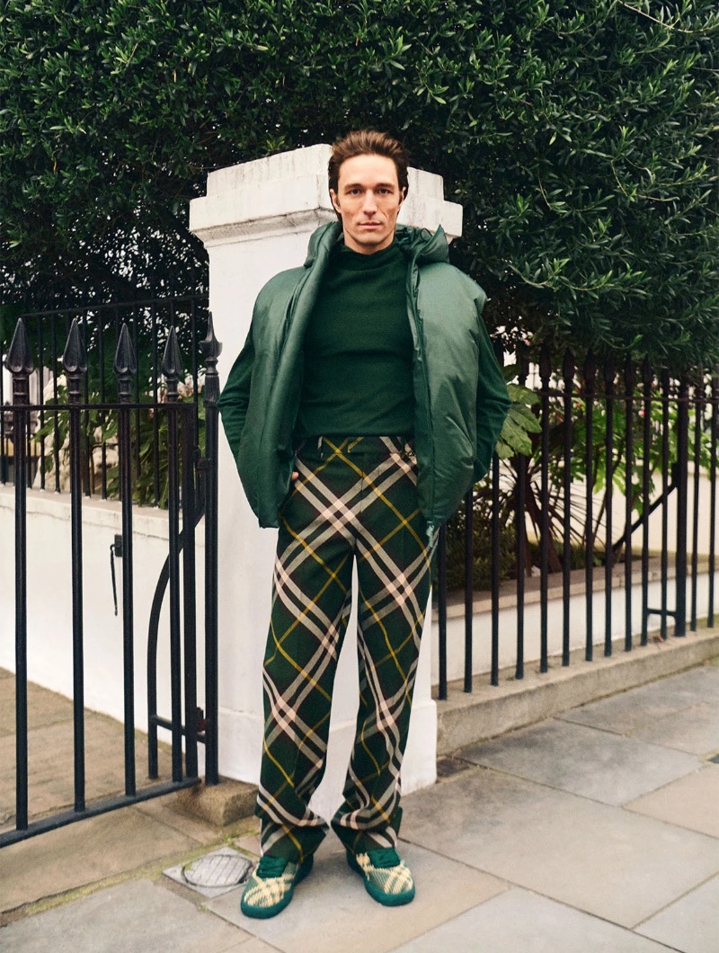 Francesco Mariottini stands out in Burberry, sporting a dynamic green ensemble with plaid trousers and coordinated sneakers.