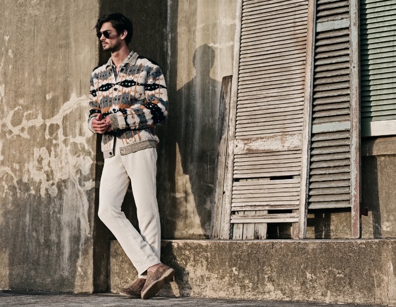 Karl Kugelmann sports a patterned cardigan and ivory pants for John Varvatos' spring 2024 campaign.