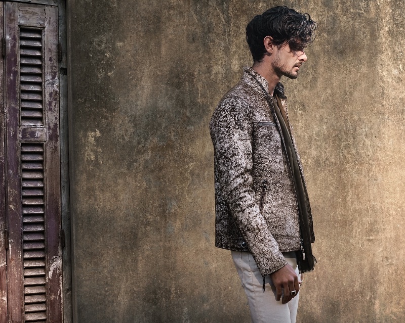 Karl Kugelmann exudes a rugged elegance in a textured jacket for John Varvatos' spring 2024 campaign.