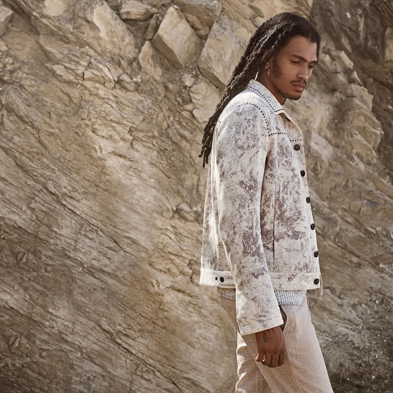 Kelvin Bueno models a statement white jacket for John Varvatos' spring 2024 campaign.