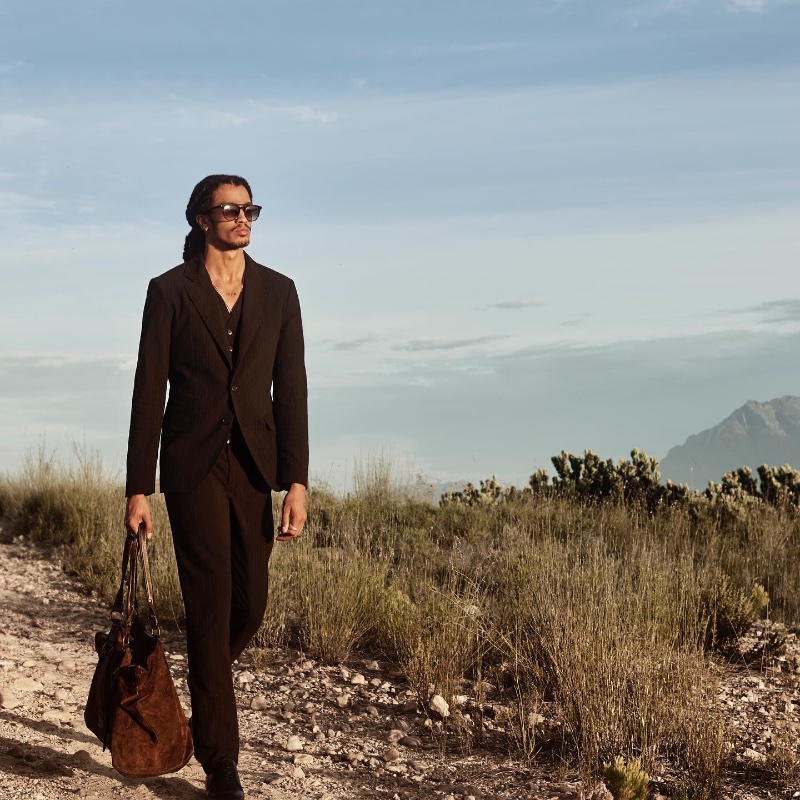 Kelvin Bueno wears a sleek black suit for John Varvatos' spring 2024 campaign.