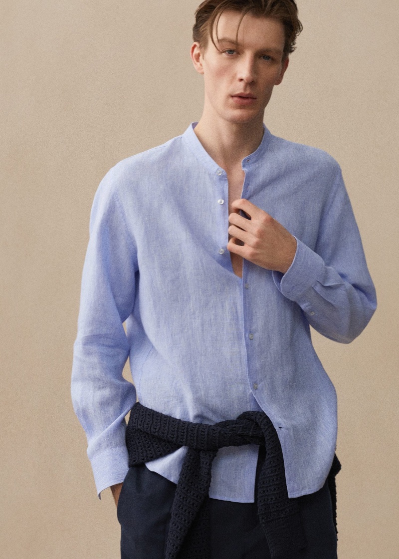 Connecting with Mango, Finnlay Davis sports a light blue linen shirt.