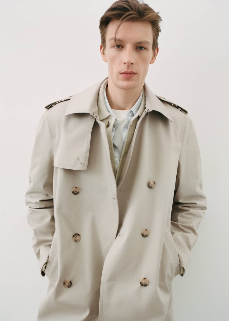 Mango's classic trench coat takes the spotlight as Finnlay Davis layers it over a striped shirt.
