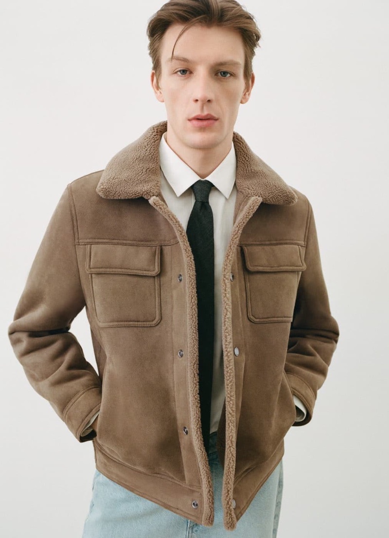 Donning a shearling-lined jacket, crisp shirt, and tie, Finnlay Davis wears Mango.