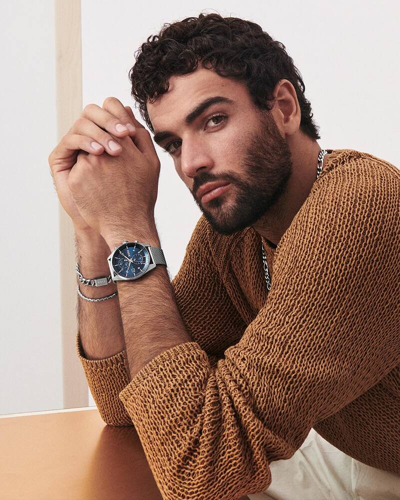 Matteo Berrettini wears a blue-dial chronograph watch with a mesh bracelet for the BOSS spring-summer 2024 watch ad.