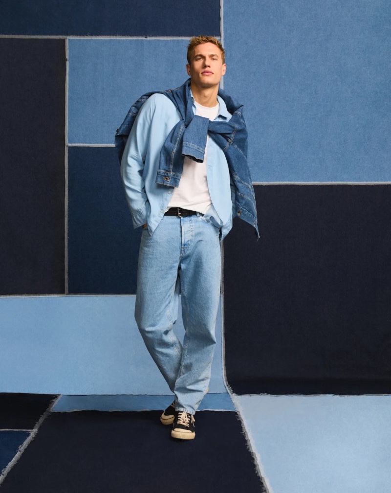 Paul François models a denim-on-denim ensemble from Pepe Jeans, anchored by classic sneakers.