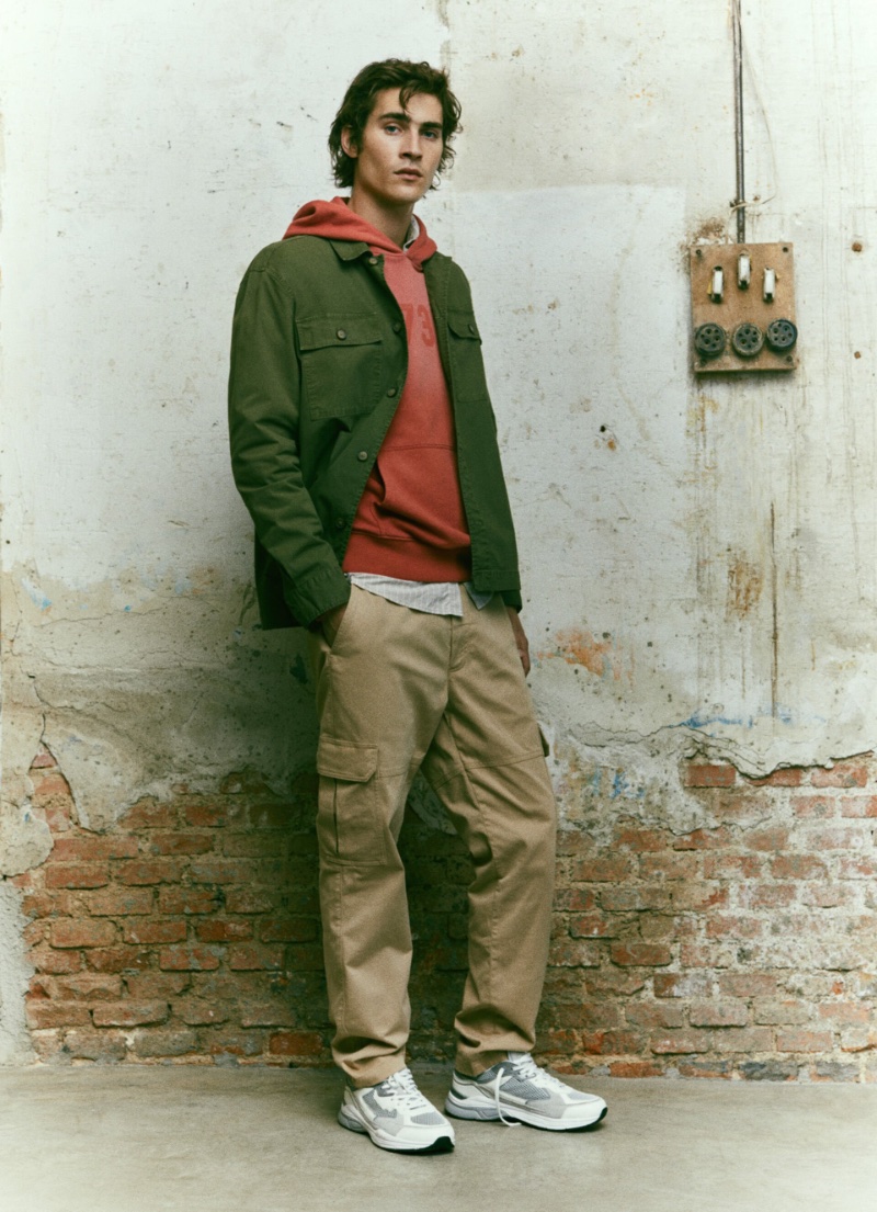 Layering, Liam Kelly wears a Pepe Jeans hoodie underneath an overshirt with cargo pants.