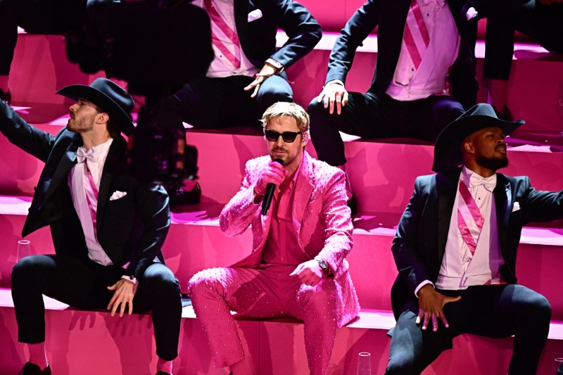 Ryan Gosling wears a crystal embellished pink Gucci suit to perform I'm Just Ken at the 2024 Oscars. 