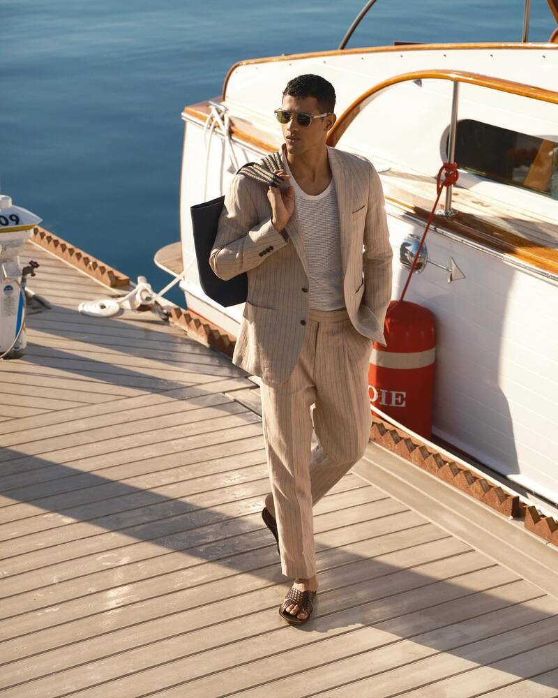 Jonas Barros is a chic vision in a Todd Snyder Italian linen Madison jacket and trousers with a mesh tank.