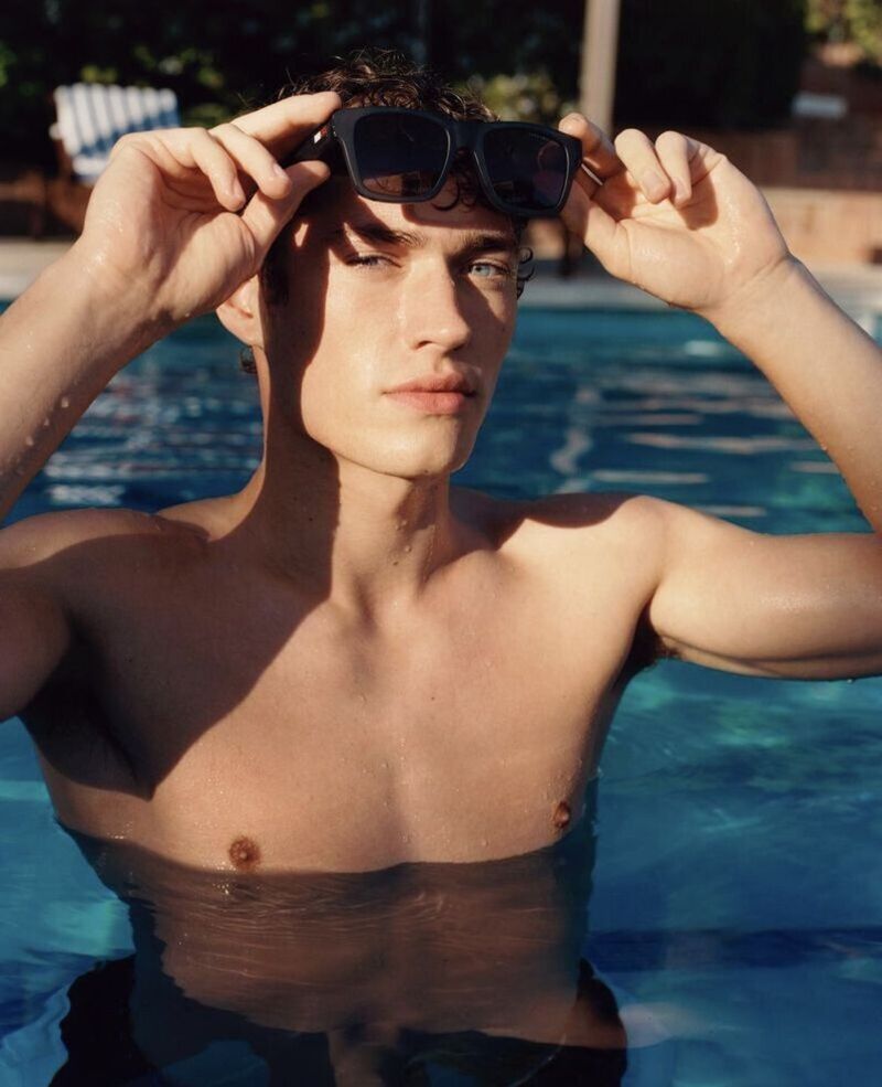 Top model Valentin Humbroich is poolside chic, donning Tommy Hilfiger's latest sunglasses. 