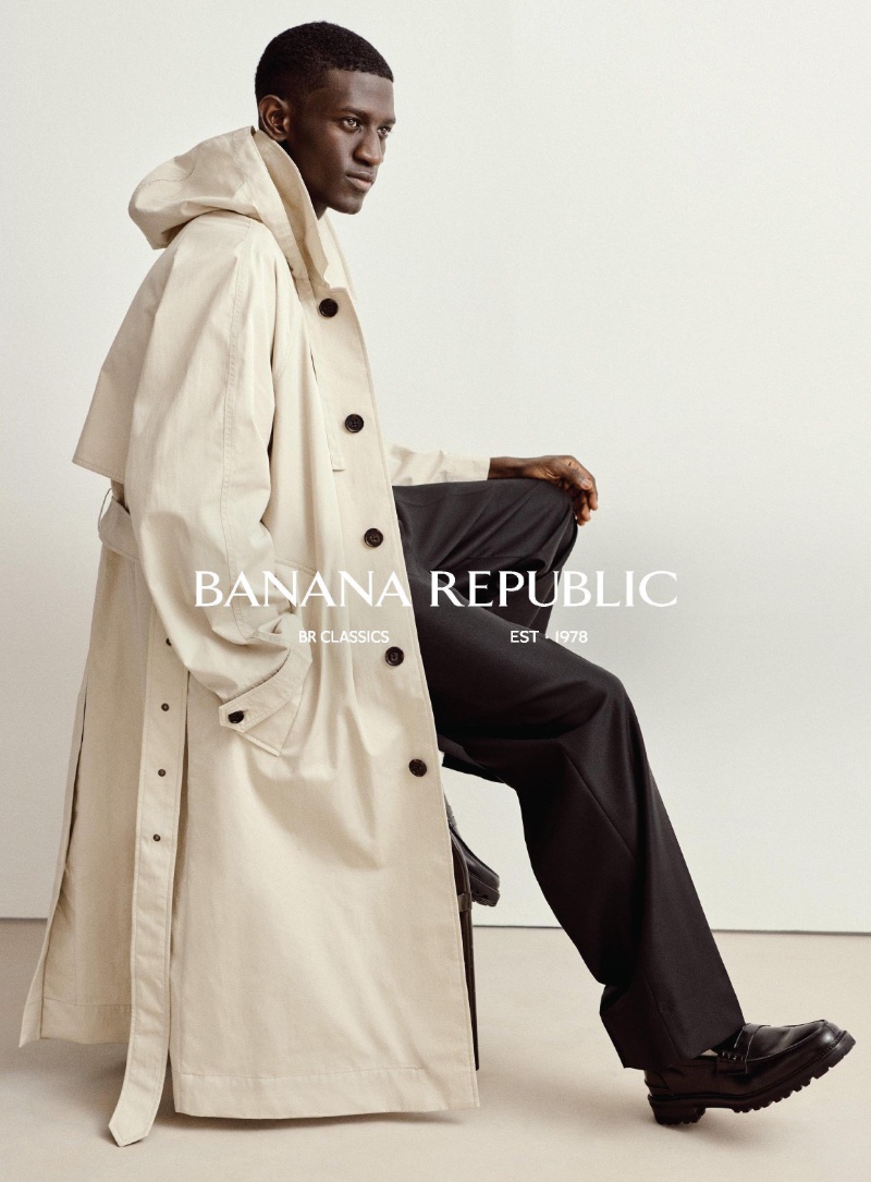 Ibby Sow exudes casual sophistication in a trench coat and black trousers from Banana Republic's spring 2024 BR Classics collection.