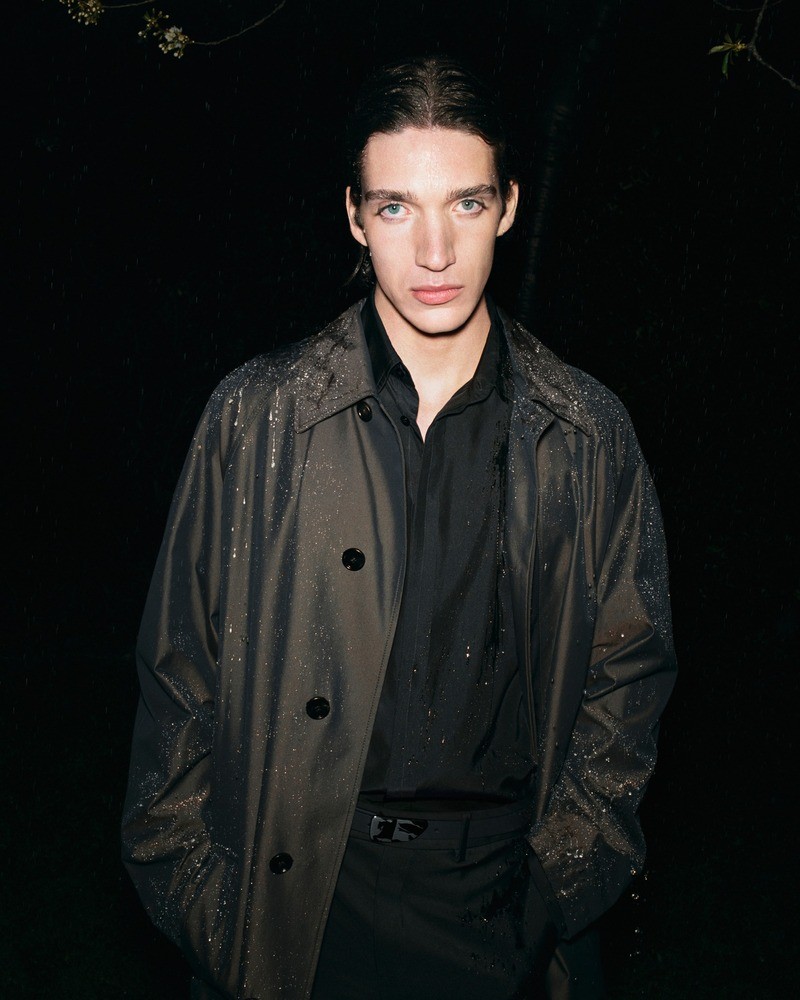 Captured after a rain shower, Taylor Gordon Bruce models a Burberry car coat for the summer 2024 campaign.