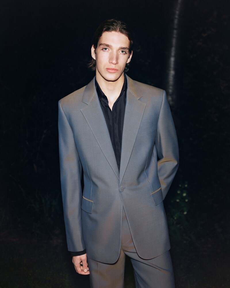 Model Taylor Gordon Bruce cuts a sleek figure in a reef Burberry suit for the summer 2024 campaign.