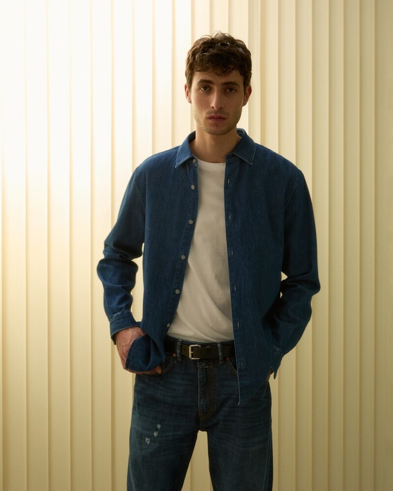 Oscar Kindelan channels classic cool in a denim shirt and jeans for Closed's summer 2024 line.
