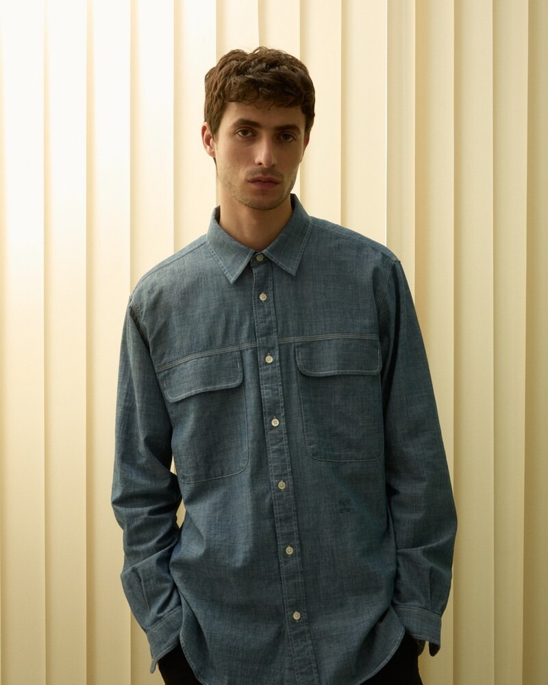 Oscar Kindelan exudes understated elegance in a classic denim shirt for Closed's summer 2024 collection.