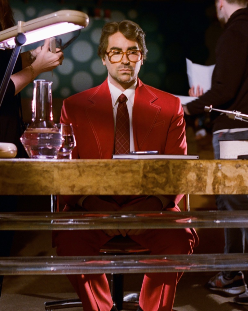 Dan Levy dons a sharp red suit, ready for action on the LOEWE campaign set.