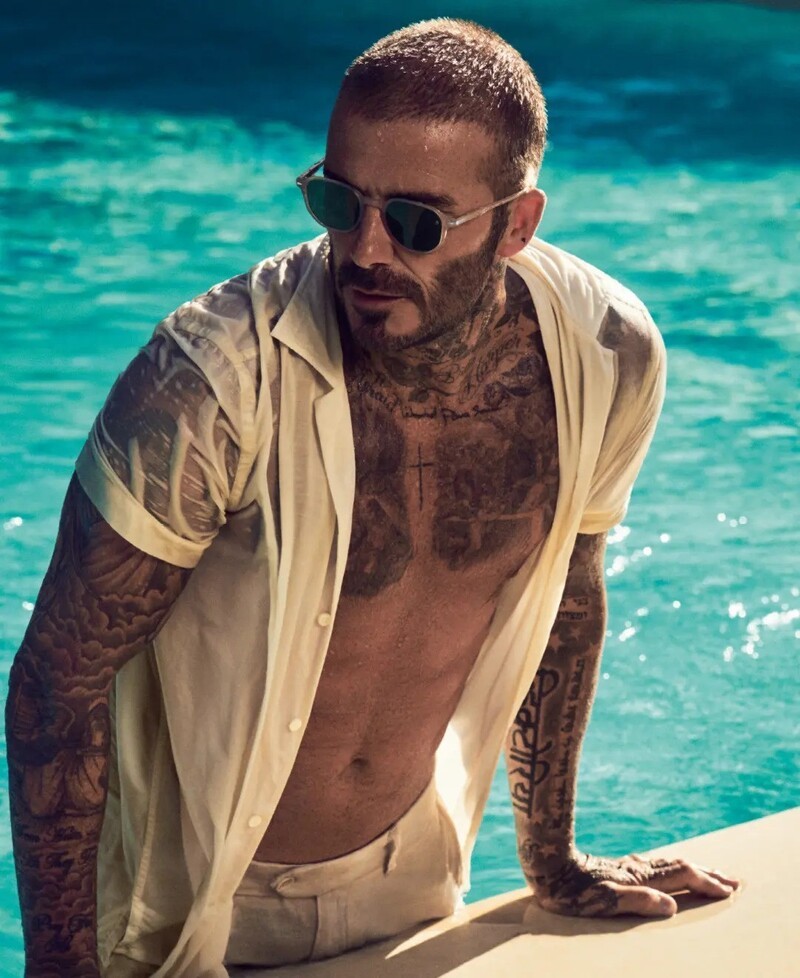 Emerging from a pool, David Beckham wears sunglasses for his spring 2024 eyewear ad.
