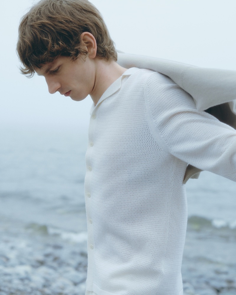 Filippa K's summer 2024 ad captures Erik van Gils in a wistful seaside moment.