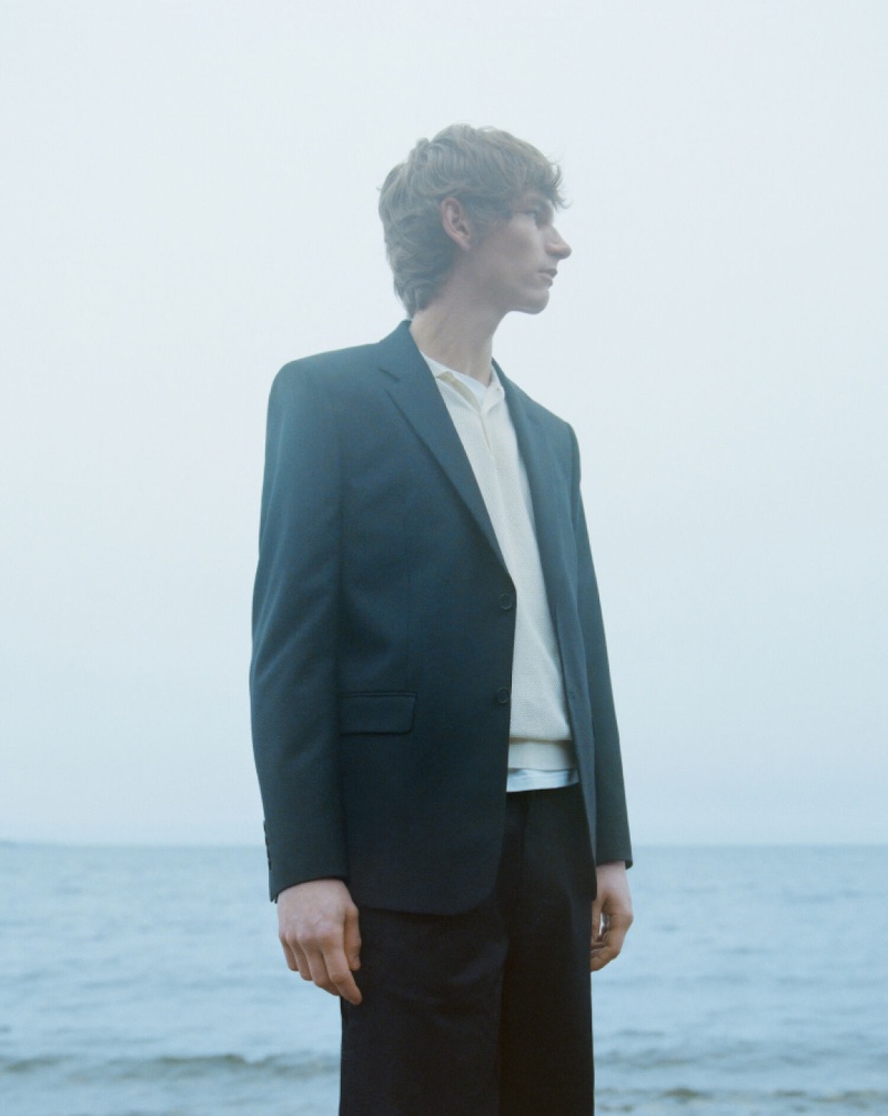 Erik van Gils models a minimalist suit for Filippa K's summer 2024 campaign.