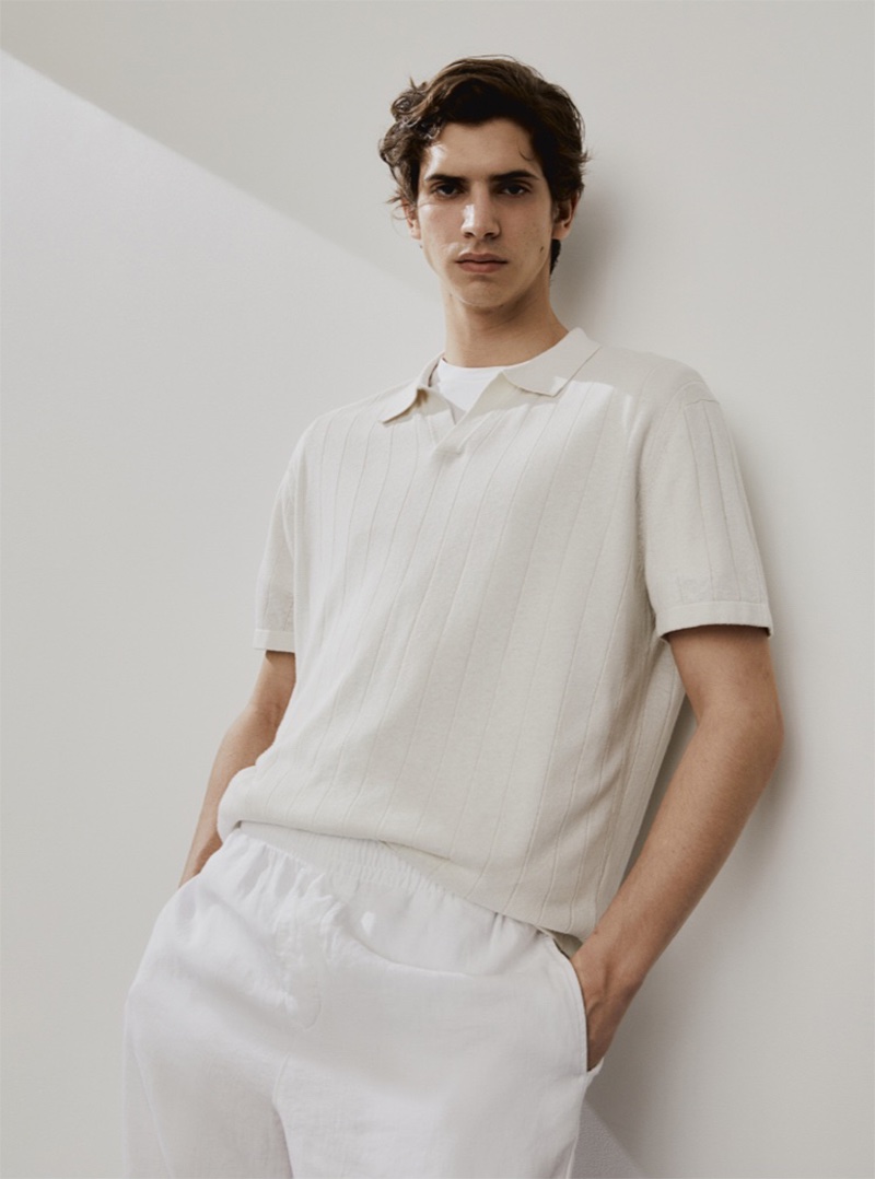 H&M's linen collection features a crisp polo and trousers, creating a minimalist chic look modeled by Hedi Ben Tekaya.