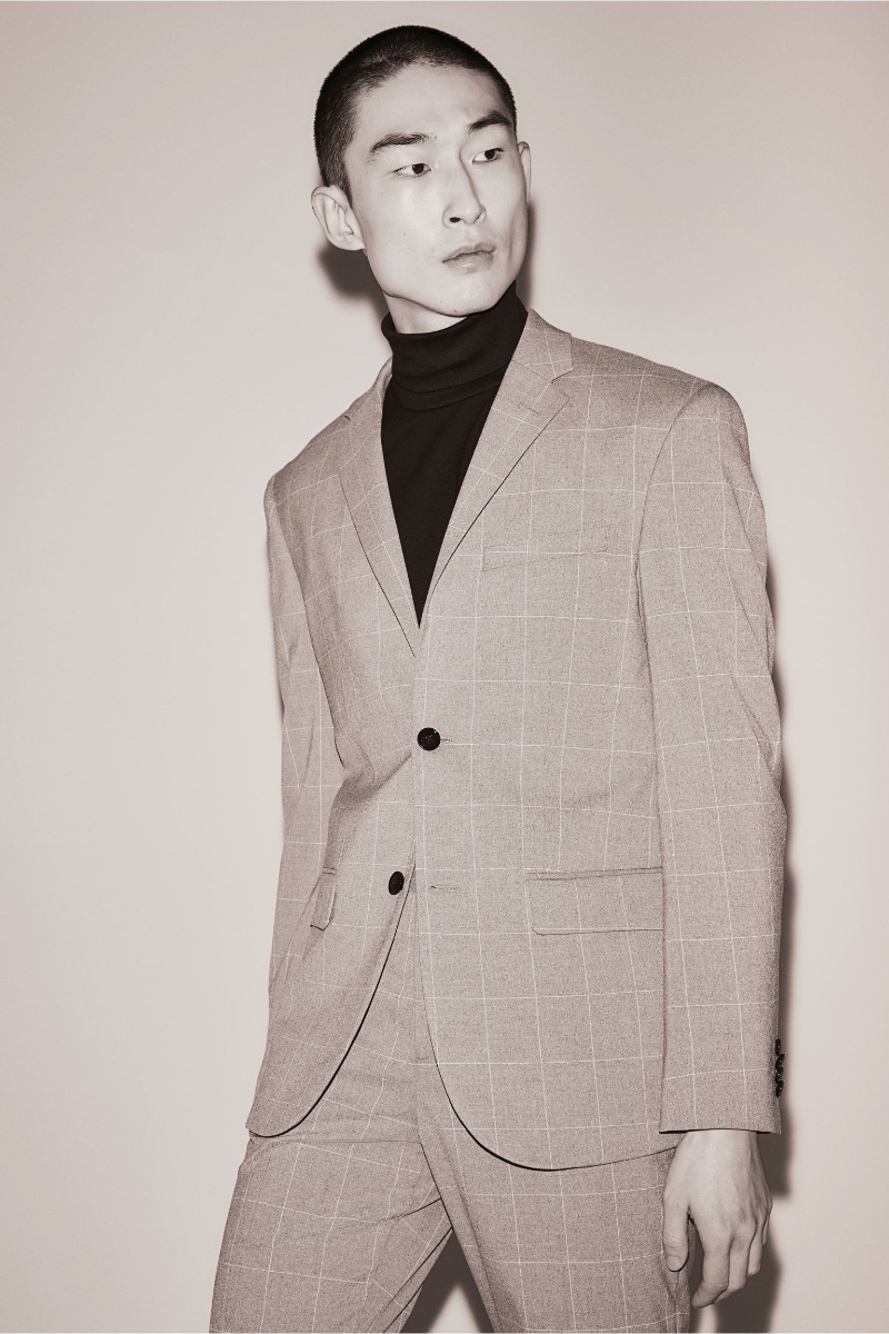 Sang Woo Kim wears a H&M windowpane suit with a black turtleneck.