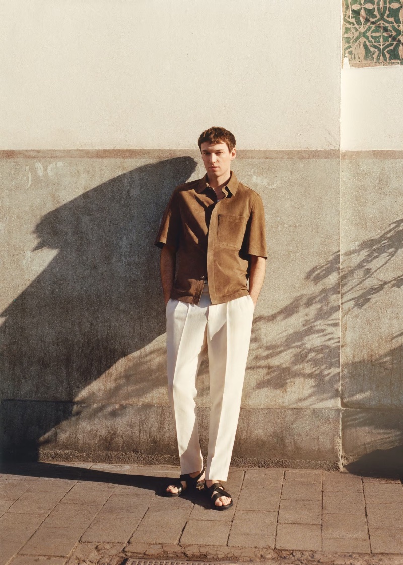 Chic materials come together as Jakob Zimny wears a suede leather overshirt with linen trousers from the Mango Designed by Boglioli collection.