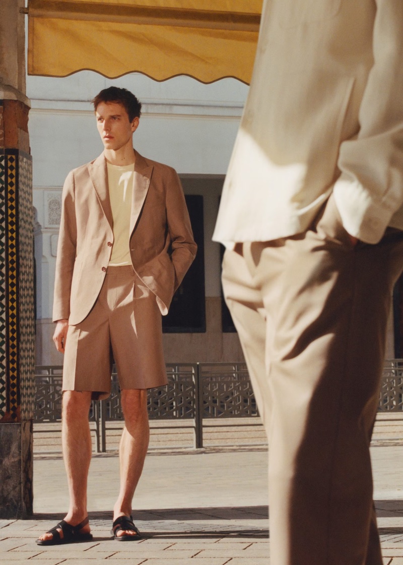 Mango Designed by Boglioli makes a sartorial statement with a linen and cotton suit jacket and Bermuda shorts modeled by Quentin Demeester.