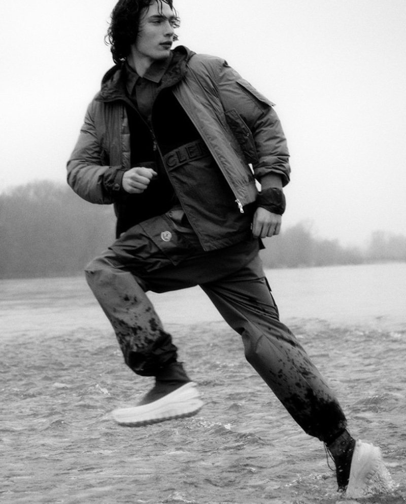 In a dynamic river scene, Freek Iven wears a Moncler jacket and cargo pants from the spring-summer 2024 collection.