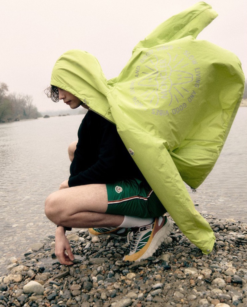 Freek Iven catches the wind in a vibrant hooded jacket from Moncler's spring-summer 2024 collection, available at LuisaViaRoma.