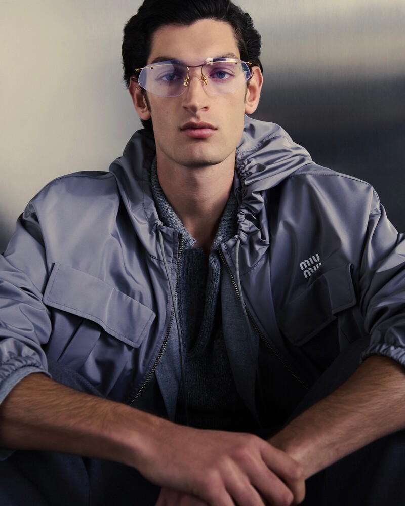 Going sporty in a Miu Miu windbreaker, Aaron Shandel also models an ERL polo sweater and Bottega Veneta sunglasses.