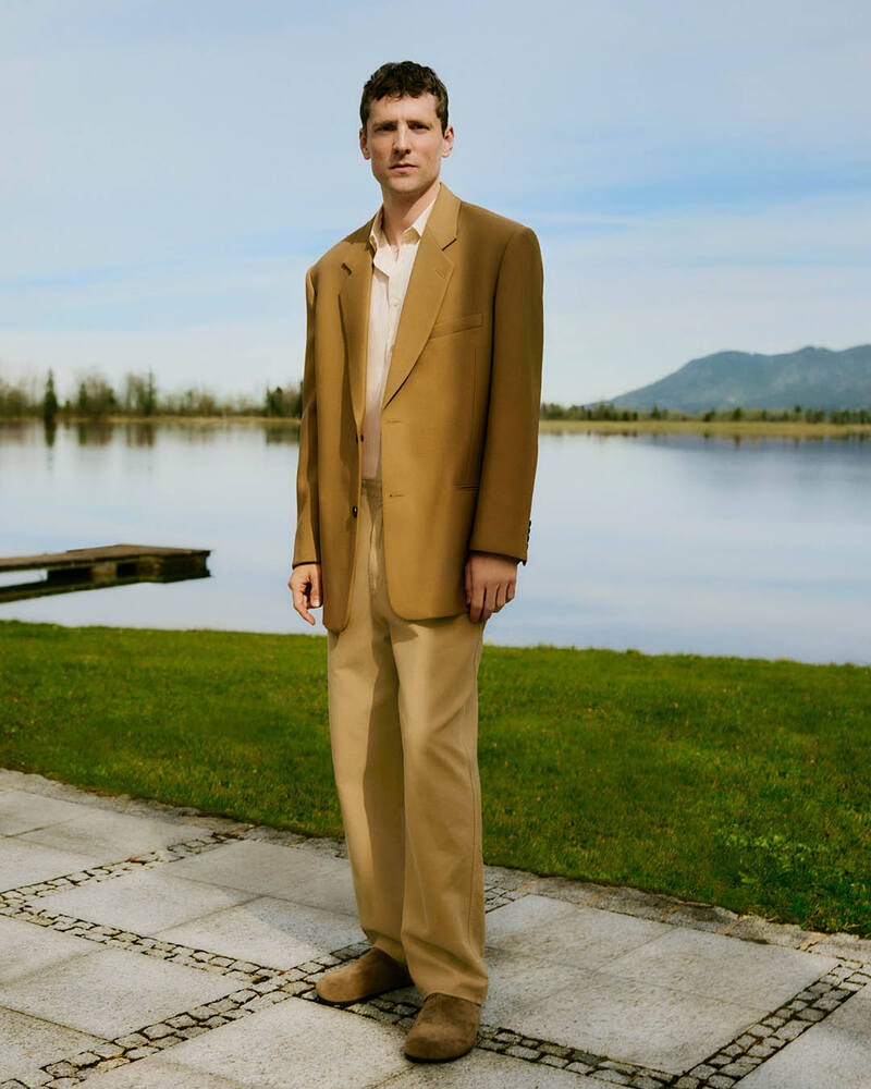 Donning neutral-colored tailoring, George Barnett wears The Row and Auralee for Mytheresa. 