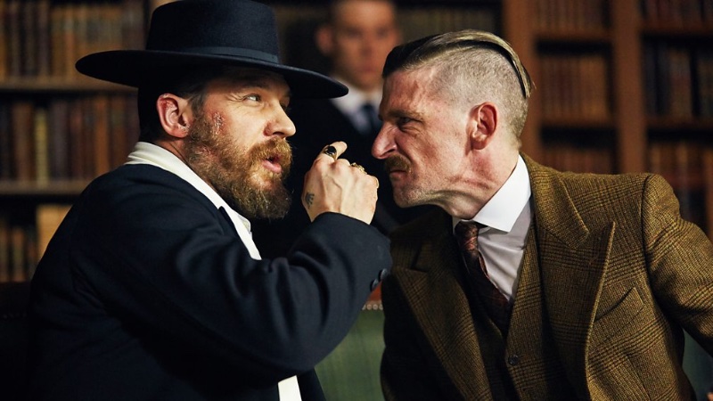 Tom Hardy's Alfie Solomons faces off against Paul Anderson's Arthur Shelby in Peaky Blinders. Emulate Arthur's formidable presence with a slicked-back look that commands attention. 