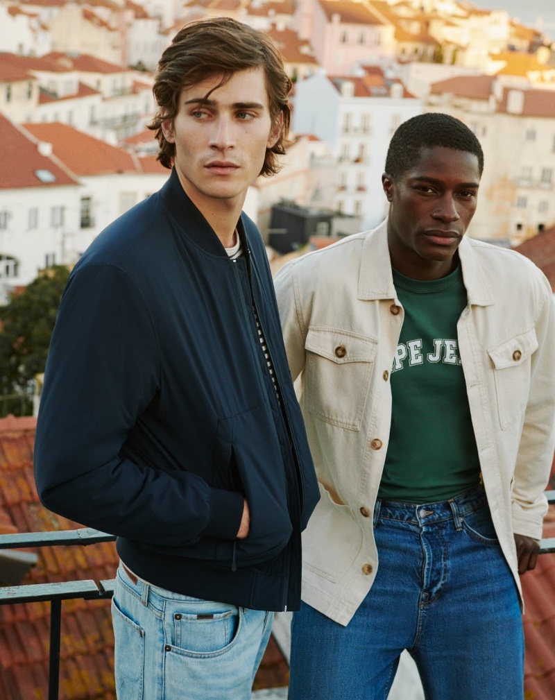 Models Liam Kelly and Mukasa Kakonge epitomize urban chic against Lisbon's skyline for Pepe Jeans' spring 2024 campaign.