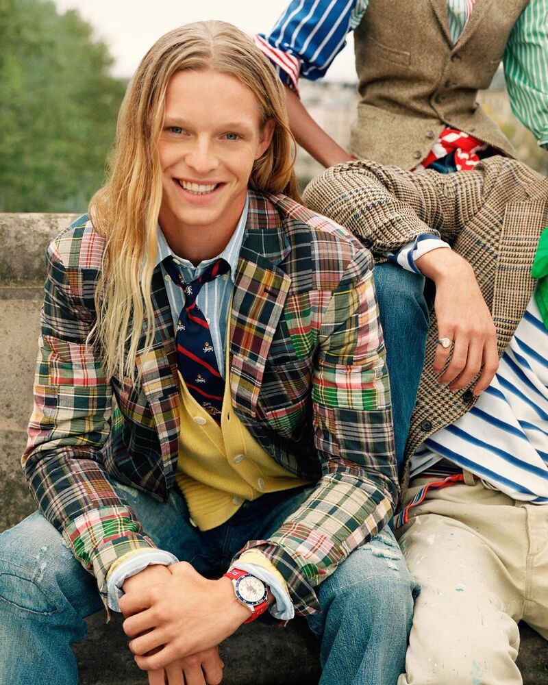 Luke Champion models a Madras blazer over a yellow cardigan and striped Oxford shirt.
