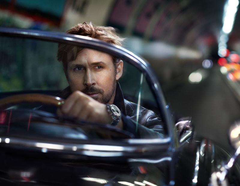 Behind the wheel, Ryan Gosling captures a moment of focus, wearing the 39mm TAG Heuer Carrera Chronograph. 