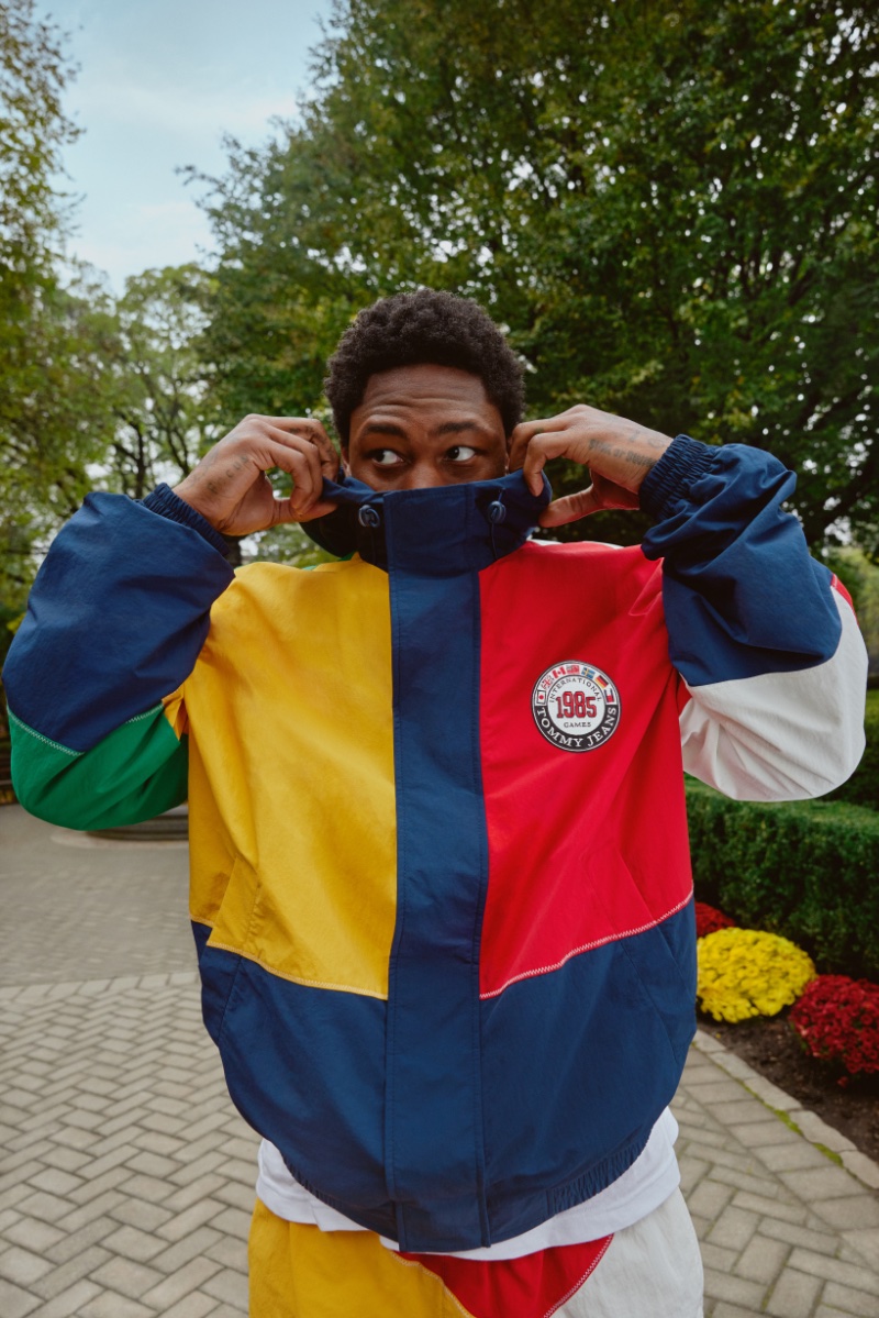 Stefon Diggs playfully pulls up the hood of his color-blocked jacket as part of the Tommy Jeans International Games campaign.