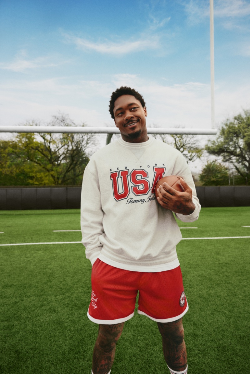 Football wide receiver Stefon Diggs is all smiles in a USA-themed Tommy Jeans sweatshirt, ready for action in the International Games ad.