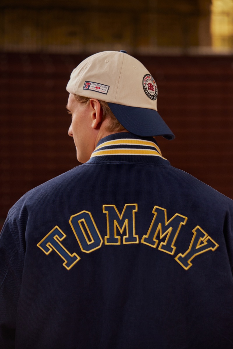 German motorsports racing driver Mick Schumacher sports a collegiate Tommy Jeans varsity jacket and cap in a nod to classic Americana for the International Games campaign. 
