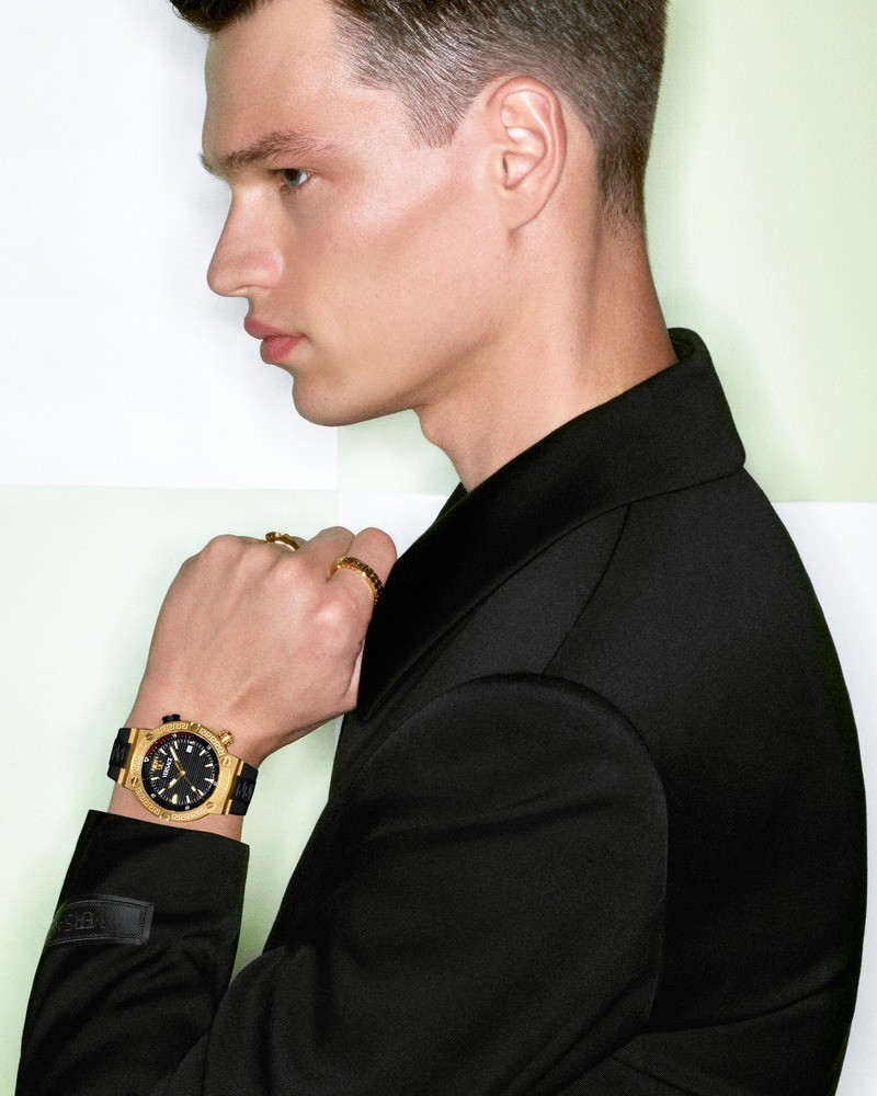 Filip Hrivnak showcases Versace's opulence with a gold-accented Greca Logo Diver watch for the spring-summer 2024 campaign.