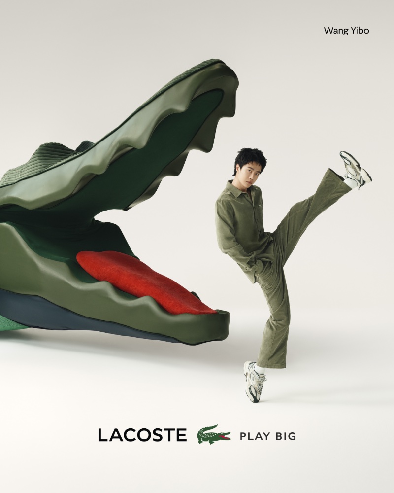 Wang Yibo kicks his leg up for the Lacoste Play Big campaign.