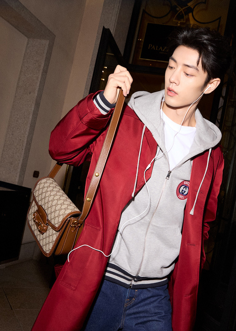 Standing out in a red coat, Xiao Zhan fronts the Gucci Horsebit 1955 bag campaign.