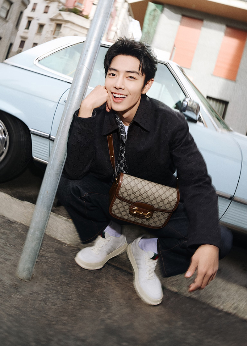 Charming with an engaging smile, Xiao Zhan stars in the new Gucci Horsebit 1955 bag campaign.