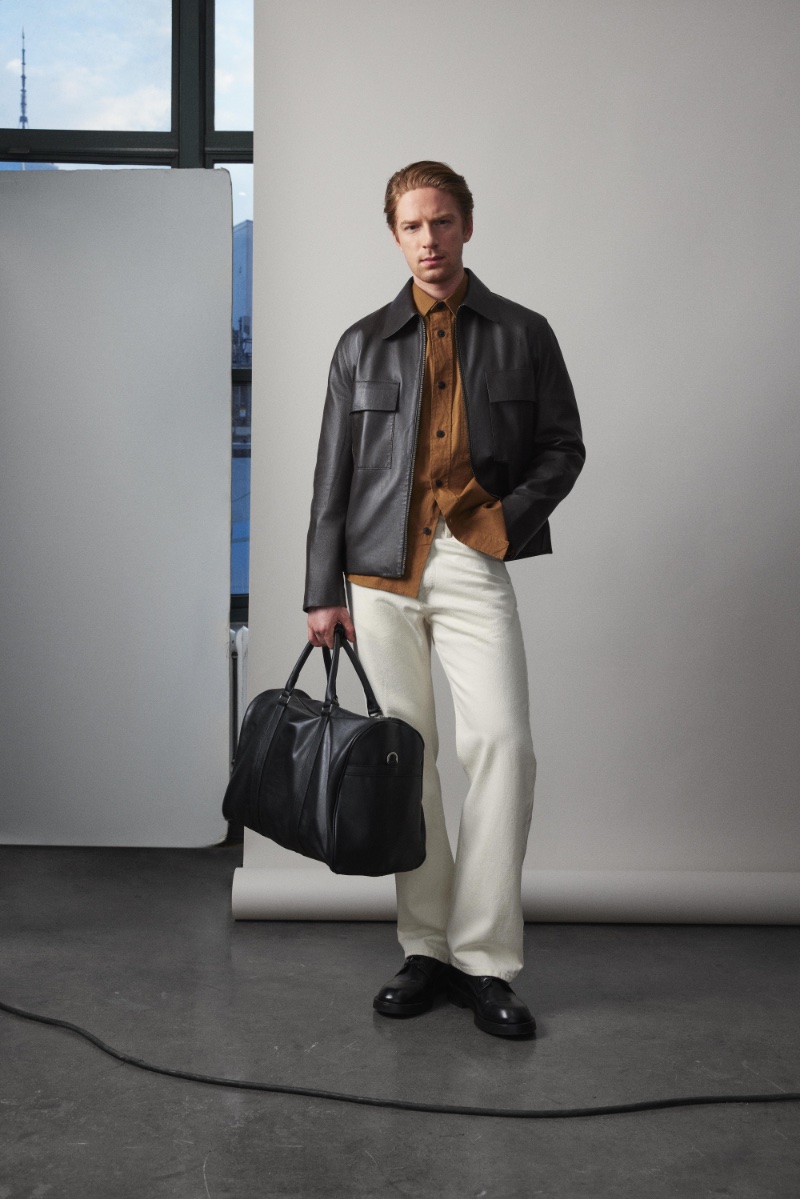 Race Imboden models a sleek leather jacket and white jeans from Zara's spring 2024 collection. 