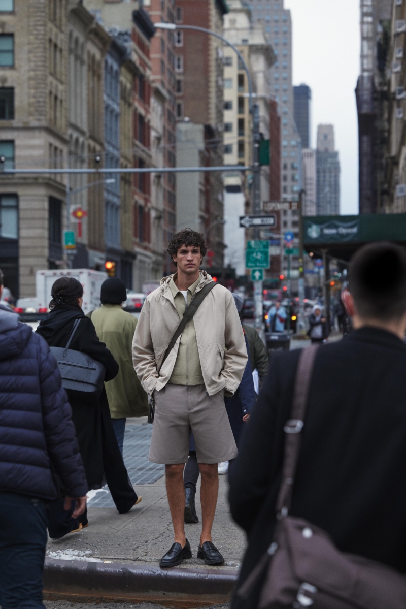 In downtown New York, Francisco Henriques stands out in Zara's spring 2024 attire, pairing a light jacket with tailored shorts and loafers. 