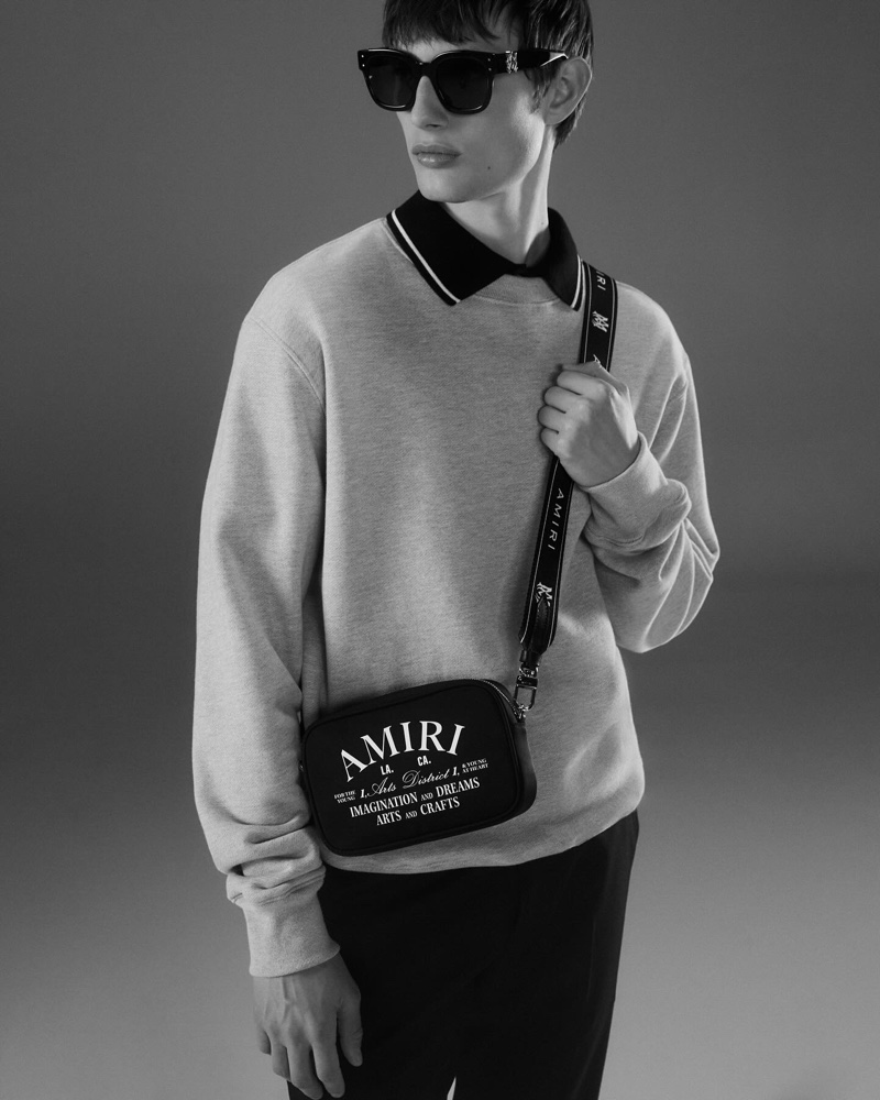 Model Thatcher Thornton sports a sweatshirt over a polo shirt for the AMIRI Core campaign. 
